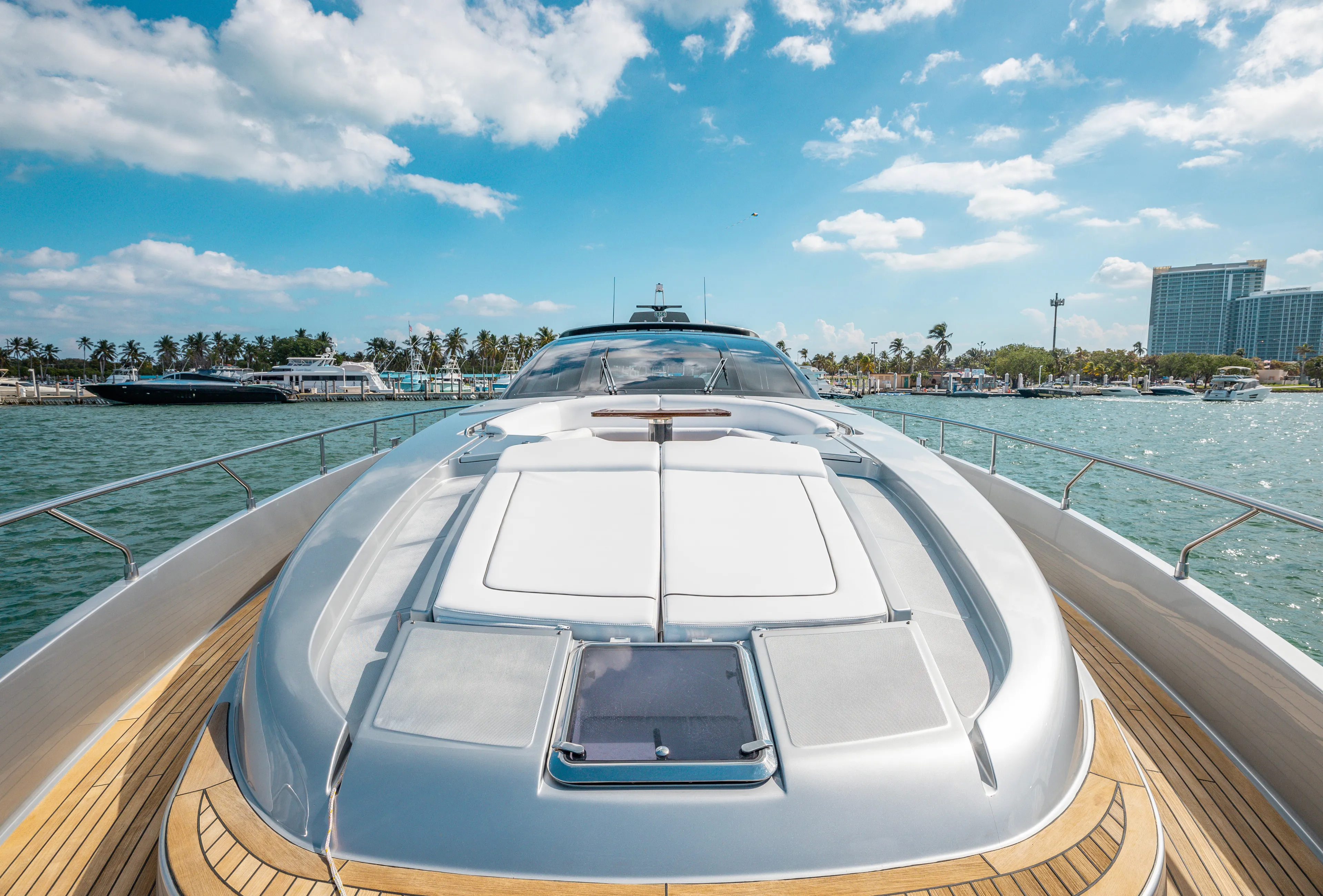 Purosangue Yacht Photos Pics Luxurious 2014 Riva 86' DOMINO yacht on serene waters under a bright blue sky.