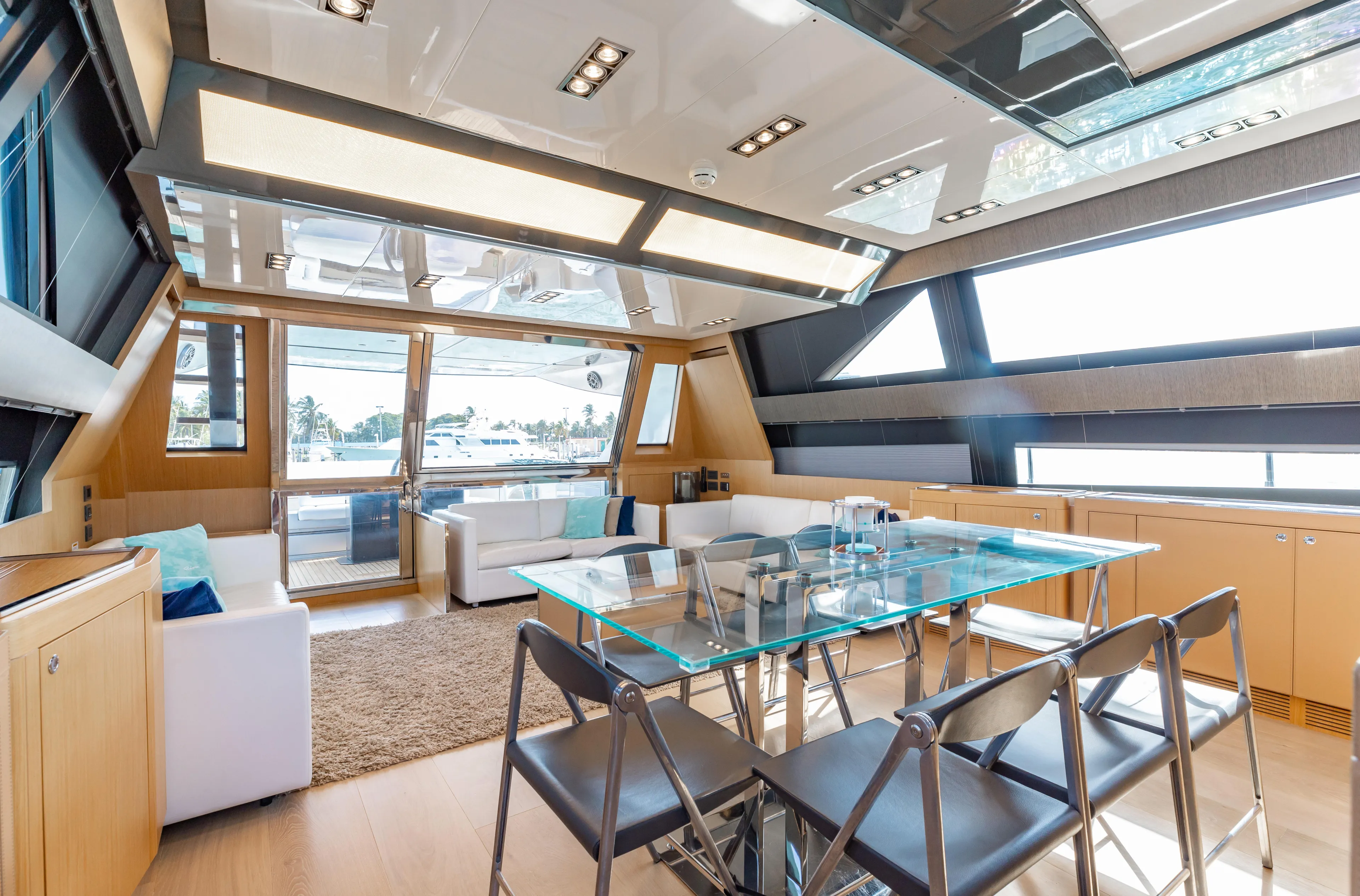 Purosangue Yacht Photos Pics Luxurious interior of 2014 Riva 86' DOMINO yacht with modern dining area and panoramic windows.