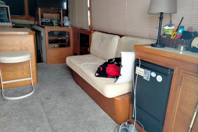 "travler" Yacht Photos Pics Interior of 1985 50' Pacifica Long Range Sportfisherman with cozy seating and wooden cabinetry.