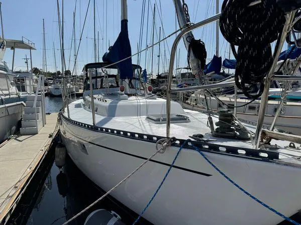 Sailboat "SEA MAID" 1989 model docked at marina, surrounded by other boats.