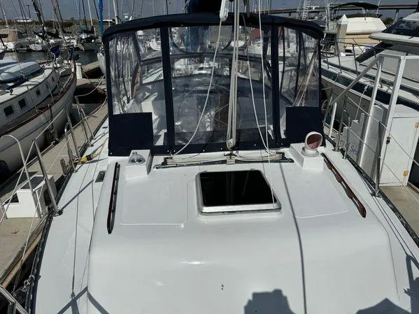 Custom 1989 SEA MAID yacht docked at marina, featuring spacious deck and clear canopy.