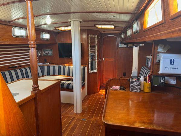 Interior of 1989 Custom SEA MAID yacht with wooden furnishings and striped seating.