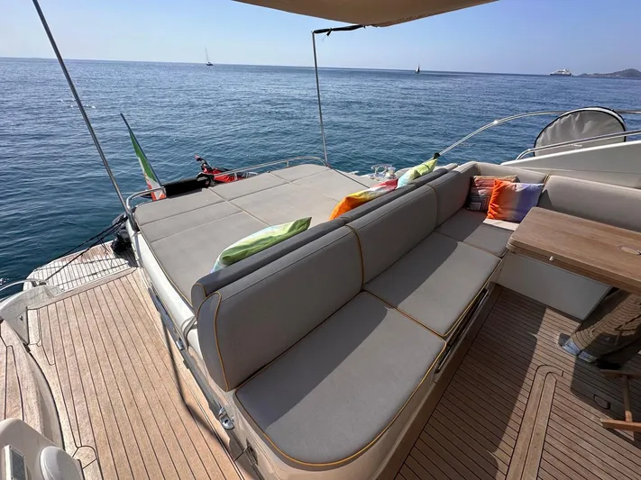  Yacht Photos Pics Luxurious 2009 Princess V62 yacht deck with comfortable seating and ocean view.