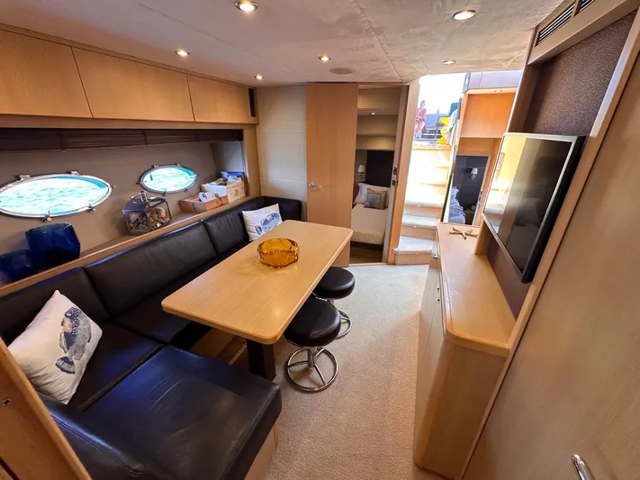  Yacht Photos Pics Luxurious interior of 2009 Princess V62 yacht with dining area and modern furnishings.