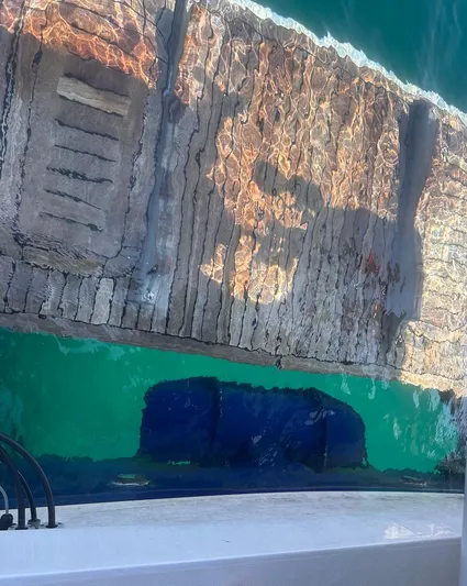  Yacht Photos Pics Reflection of a dock and water beside a 2009 Princess V62 yacht.