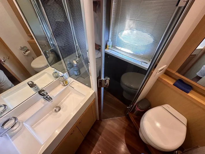  Yacht Photos Pics Luxurious bathroom in 2009 Princess V62 yacht with modern fixtures and wooden flooring.