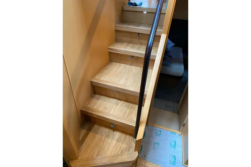  Yacht Photos Pics Wooden staircase inside 2009 Princess V62 yacht, leading to lower cabin area.