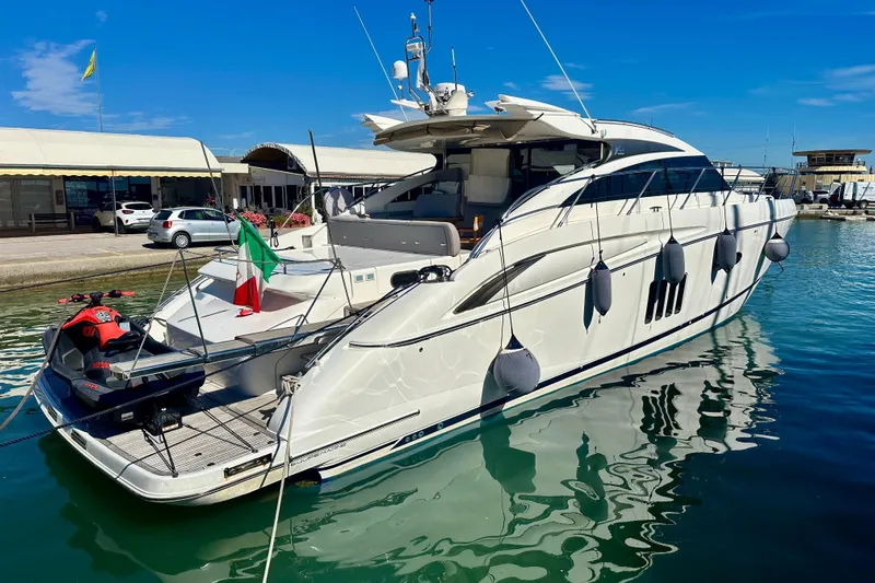  Yacht Photos Pics Luxury 2009 Princess V62 yacht docked in marina with Italian flag and jet ski.
