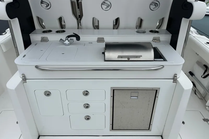 Bali Hai Yacht Photos Pics Outdoor kitchen setup on a 2020 Edgewater 370CC boat, featuring a grill and sink.