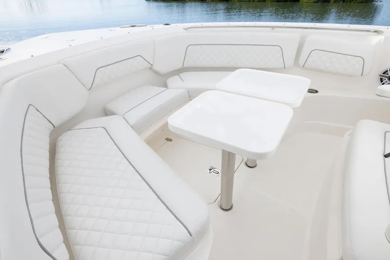  Yacht Photos Pics Manufacturer Provided Image: Luxurious seating area on 2025 Pursuit S 328 Sport boat with white upholstery and tables.