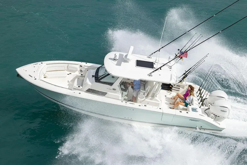  Yacht Photos Pics Manufacturer Provided Image: 2025 Pursuit S 328 Sport boat cruising on ocean with fishing rods.