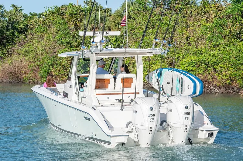  Yacht Photos Pics Manufacturer Provided Image: 2025 Pursuit S 328 Sport boat cruising with dual engines and paddleboards.
