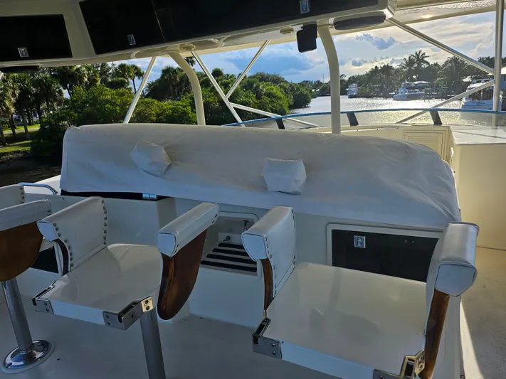 Yacht Photos Pics 1991 Donzi 65 Sportfisherman boat cockpit with covered seating and helm chairs.