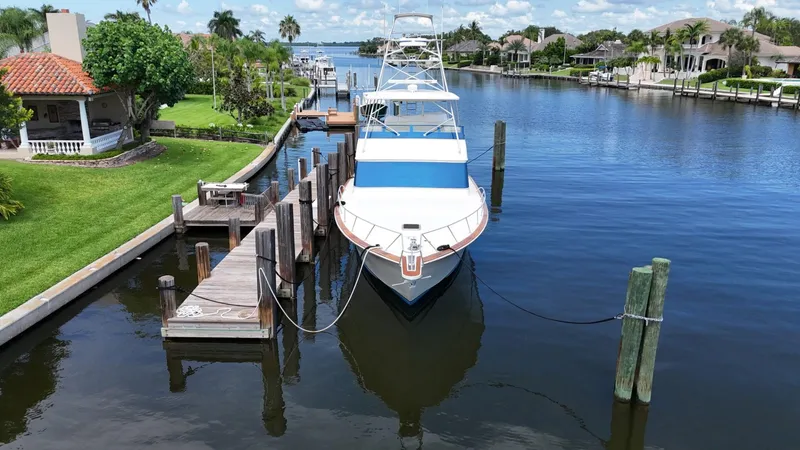  Yacht Photos Pics 1991 Donzi 65 Sportfisherman docked in a scenic canal.