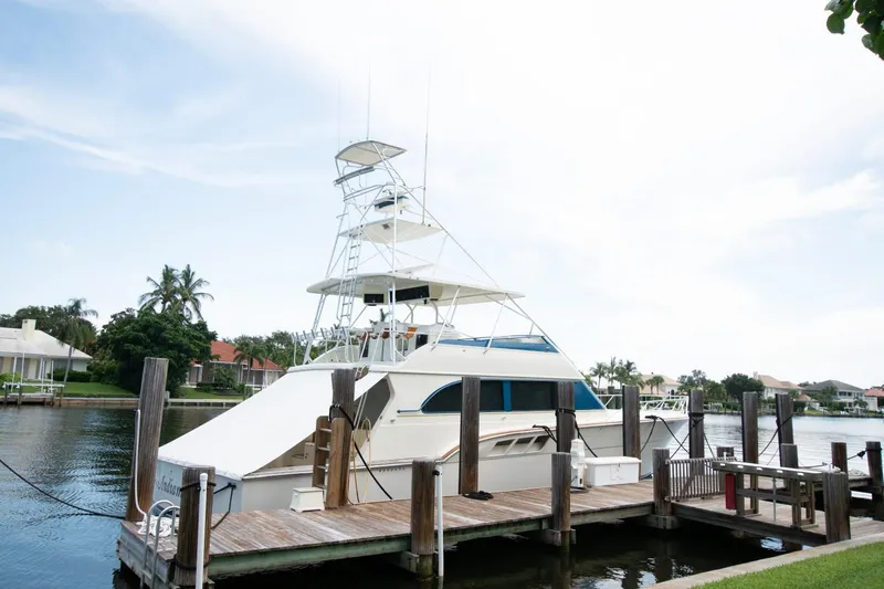  Yacht Photos Pics 1991 Donzi 65 Sportfisherman yacht docked at a marina.
