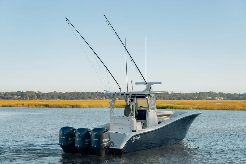  Yacht Photos Pics 2014 Yellowfin 34 Offshore boat with triple Yamaha engines on calm water.