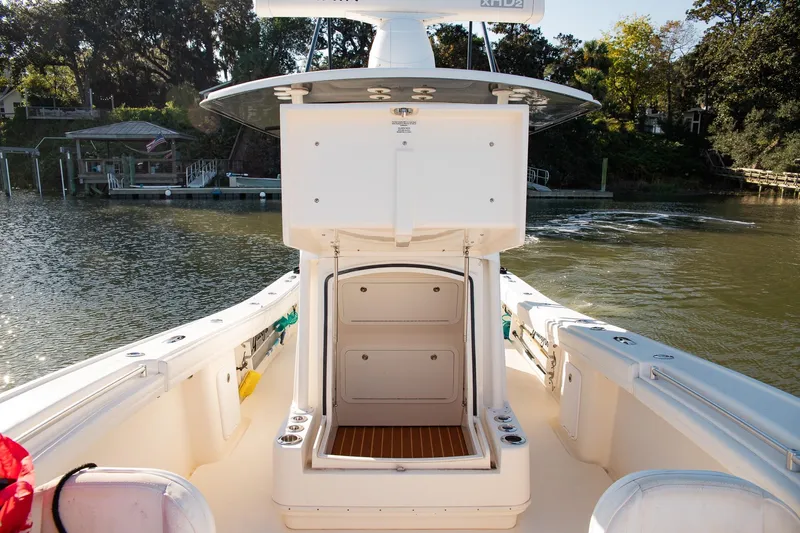  Yacht Photos Pics 2014 Yellowfin 34 Offshore boat interior with open storage, docked by a scenic waterfront.