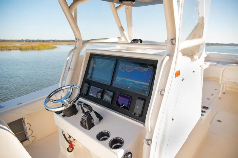  Yacht Photos Pics 2014 Yellowfin 34 Offshore boat console with advanced navigation system on calm water.