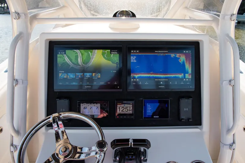  Yacht Photos Pics Dashboard of a 2014 Yellowfin 34 Offshore boat with navigation screens.