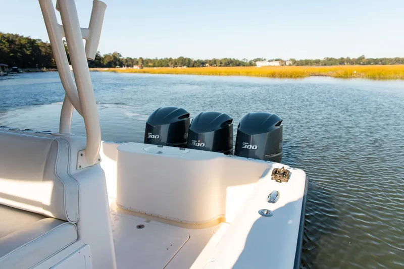  Yacht Photos Pics 2014 Yellowfin 34 Offshore boat with triple 300 horsepower engines on calm water.