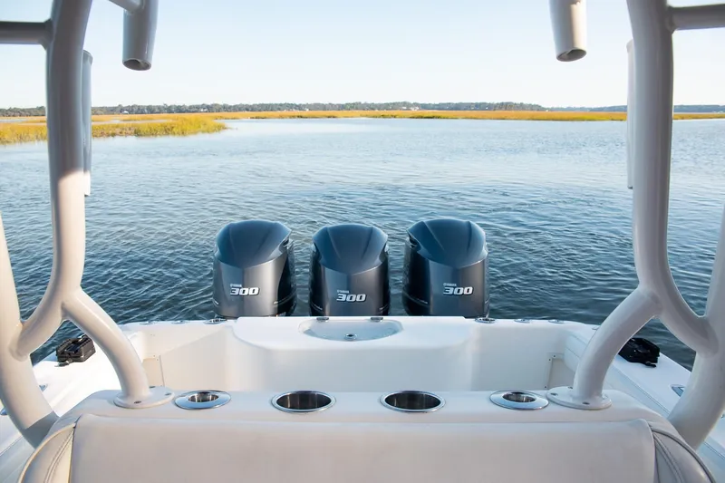  Yacht Photos Pics 2014 Yellowfin 34 Offshore boat with triple 300 horsepower engines on a calm waterway.