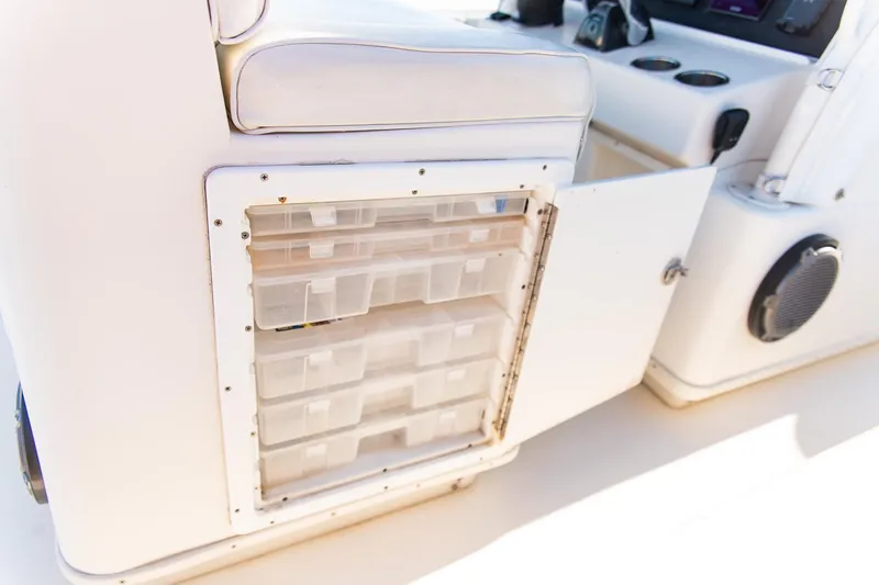  Yacht Photos Pics 2014 Yellowfin 34 Offshore boat storage compartment with open door and organized containers.