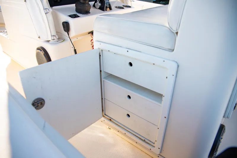  Yacht Photos Pics 2014 Yellowfin 34 Offshore boat interior storage compartment with open door and drawers.