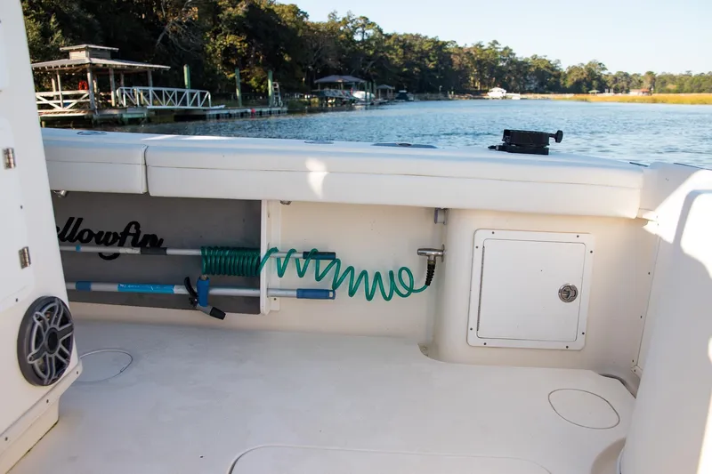  Yacht Photos Pics 2014 Yellowfin 34 Offshore boat interior with storage and hose, dockside view.