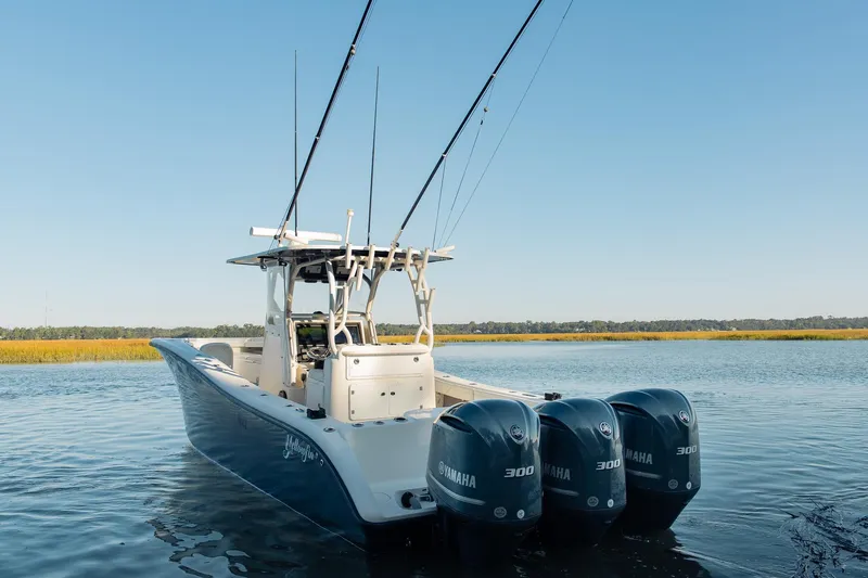  Yacht Photos Pics 2014 Yellowfin 34 Offshore boat with triple Yamaha engines on calm water.