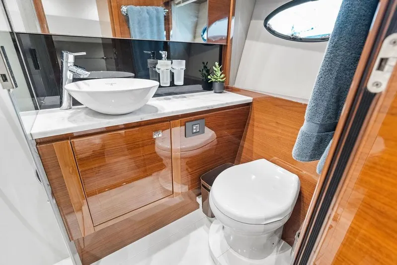 One Life Yacht Photos Pics Luxurious bathroom in 2016 Princess 60 Flybridge Motor Yacht with modern fixtures and wood accents.