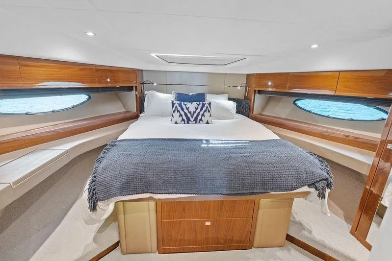 One Life Yacht Photos Pics Luxurious bedroom interior of 2016 Princess 60 Flybridge Motor Yacht with elegant wood finishes.