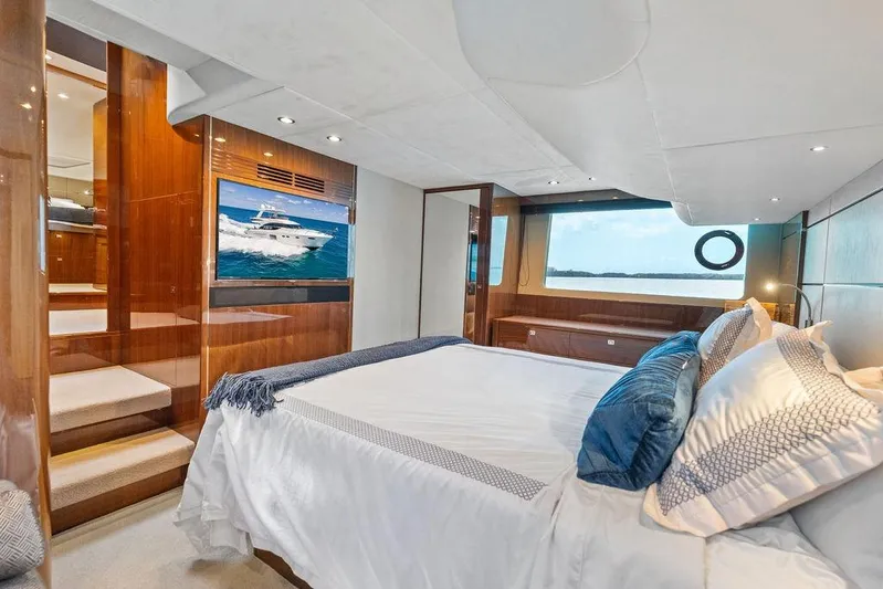 One Life Yacht Photos Pics Luxurious bedroom interior of 2016 Princess 60 Flybridge Motor Yacht with elegant wood finishes.