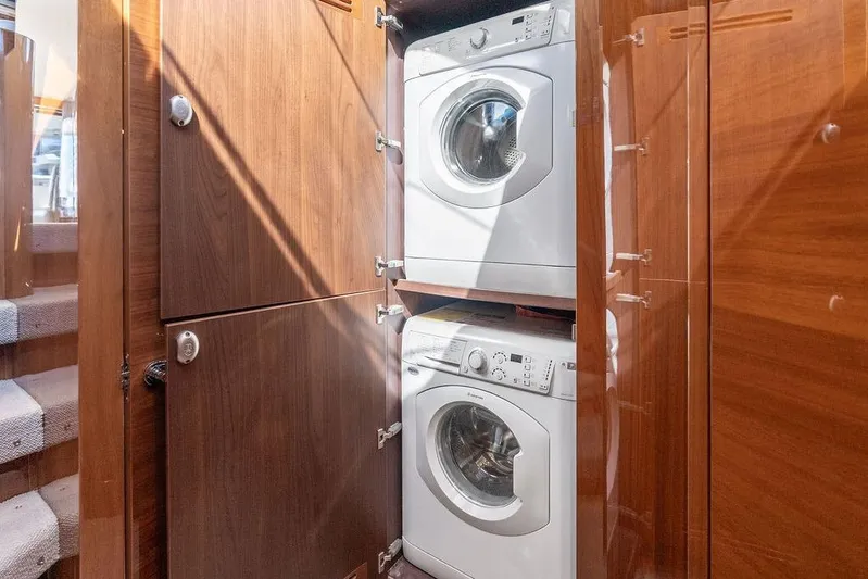 One Life Yacht Photos Pics Laundry area with stacked washer and dryer in 2016 Princess 60 Flybridge Yacht.