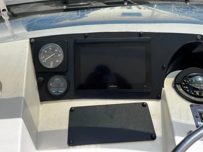 Charlie's Angels Yacht Photos Pics 1991 Hatteras 52 Cockpit Motoryacht dashboard with Garmin display and compass.