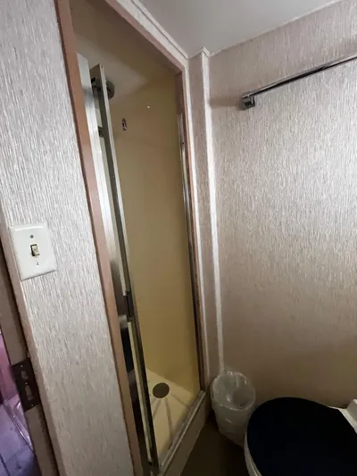 Charlie's Angels Yacht Photos Pics Bathroom interior of 1991 Hatteras 52 Cockpit Motoryacht with shower and toilet.