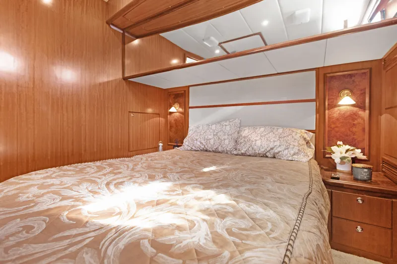  Yacht Photos Pics Luxurious bedroom interior of 2006 Noresman 480 Sedan yacht with elegant wood paneling.