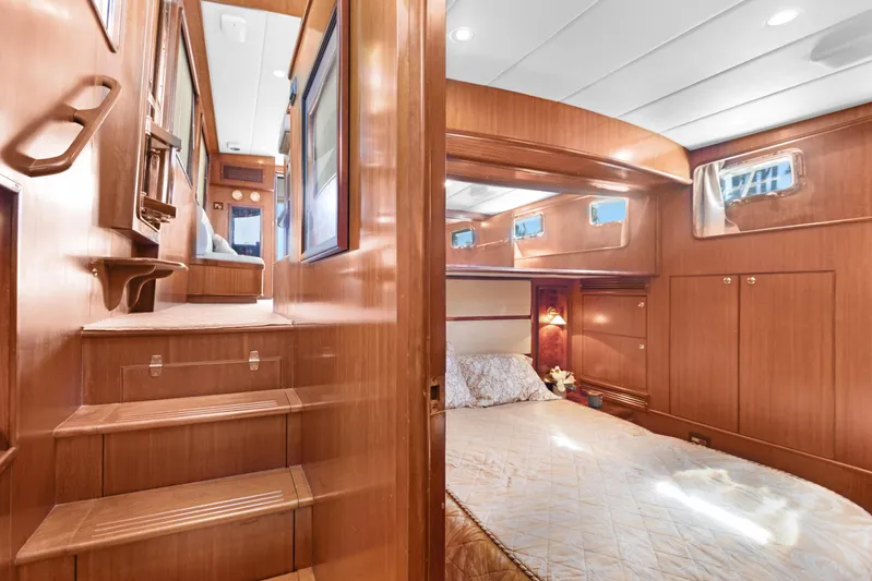  Yacht Photos Pics Luxurious interior of 2006 Noresman 480 Sedan yacht with cozy bedroom and wooden finishes.
