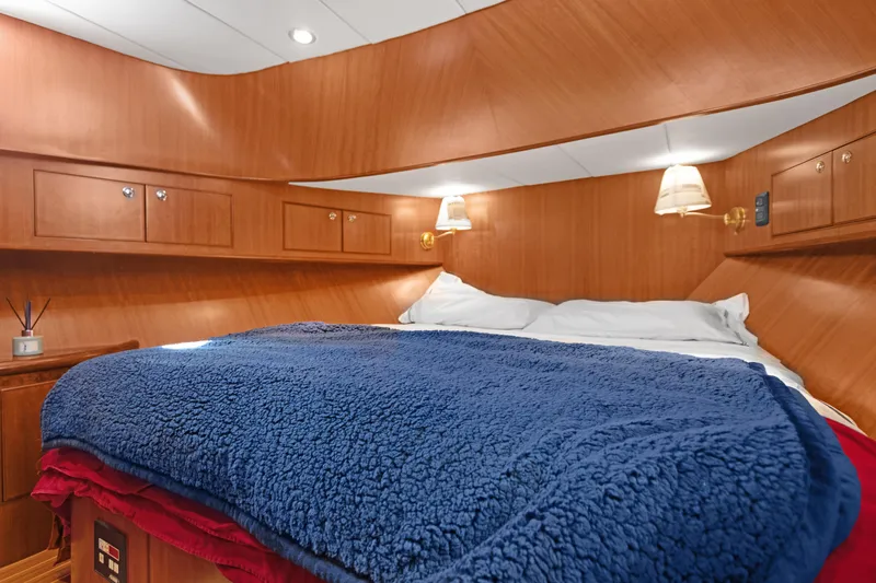  Yacht Photos Pics Luxurious cabin interior of 2006 Noresman 480 Sedan with cozy bedding and wooden finish.