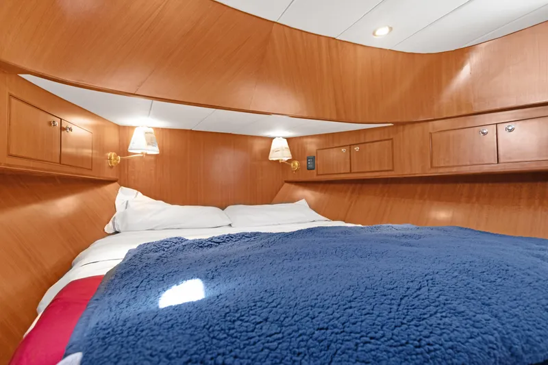  Yacht Photos Pics Luxurious cabin interior of 2006 Noresman 480 Sedan with cozy bedding and wooden finish.
