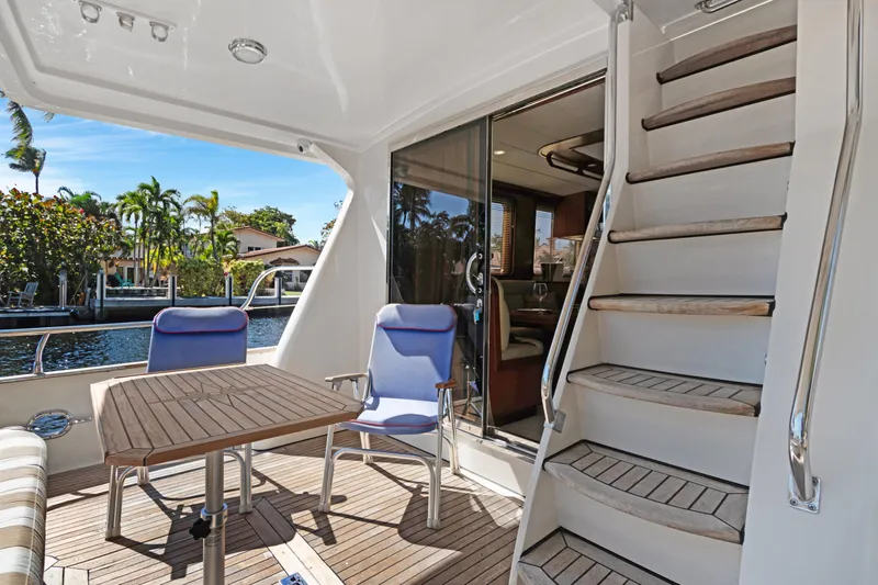  Yacht Photos Pics Luxury 2006 Noresman 480 Sedan yacht deck with seating, table, and stairs.