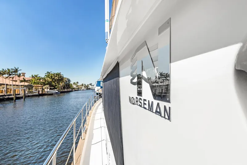  Yacht Photos Pics Side view of 2006 Noresman 480 Sedan yacht on a sunny waterway.