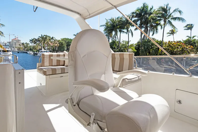  Yacht Photos Pics Luxury Noresman 480 Sedan yacht interior with plush seating, palm trees, and waterfront view.