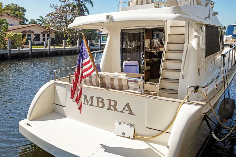  Yacht Photos Pics Luxury 2006 Noresman 480 Sedan yacht docked, featuring American flag and elegant design.