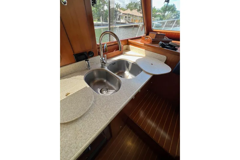  Yacht Photos Pics 2006 Norseman 480S yacht kitchen with dual sinks and wooden cabinetry.