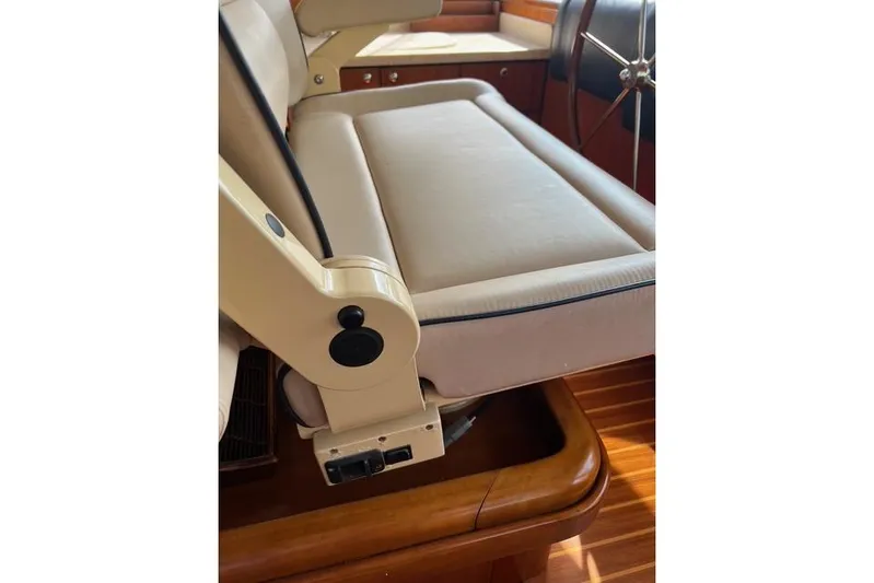  Yacht Photos Pics Captain's seat on 2006 Norseman 480S yacht, featuring beige upholstery and wooden flooring.