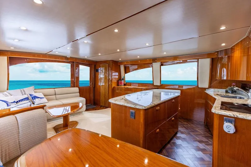 Harbor Time Yacht Photos Pics Luxurious interior of 2013 Viking 66 Open yacht with ocean view, featuring elegant wood finishes.