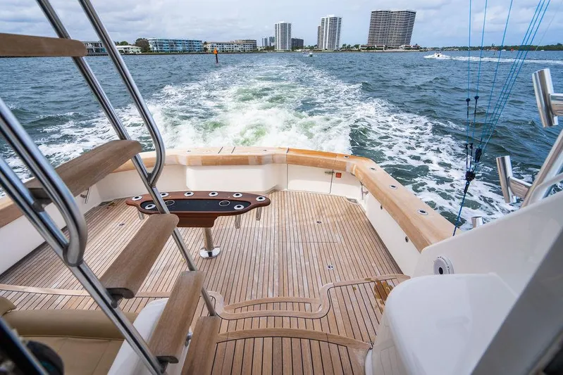 Harbor Time Yacht Photos Pics Viking 66 Open 2013 yacht cruising with city skyline in background.