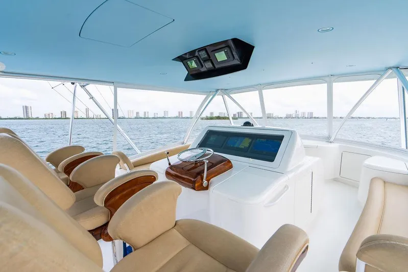 Harbor Time Yacht Photos Pics Interior of 2013 Viking 66 Open yacht with helm and seating, overlooking water.