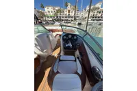 2008 Rinker 228 DB boat interior with steering wheel, docked in a marina.