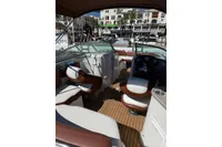 2008 Rinker 228 DB boat interior with seating and steering wheel, docked at marina.